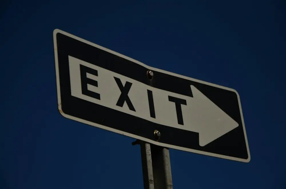 The exit sign points towards the right direction, illustrating career direction